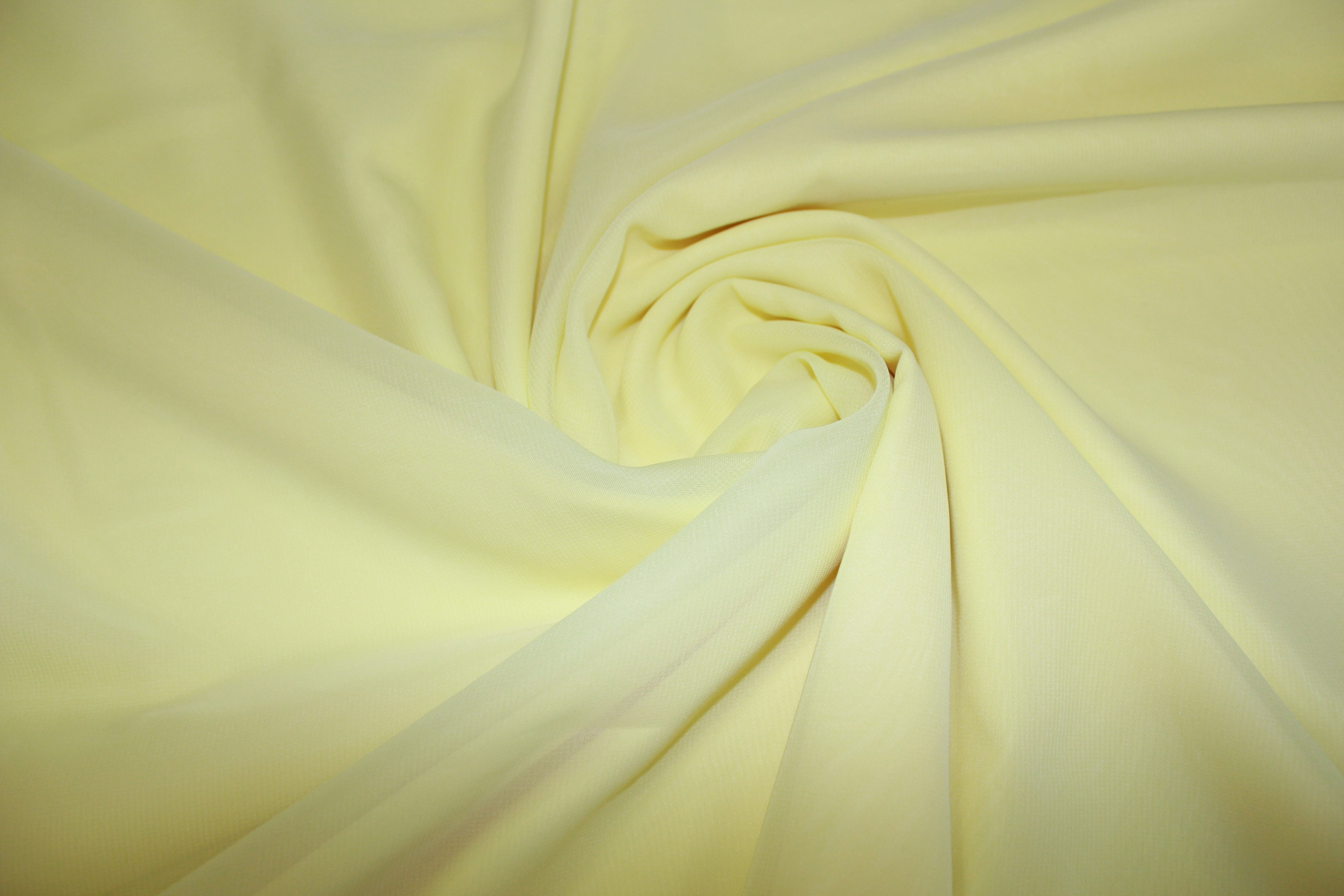 Тонкая ткань. Светло желтая ткань. Желтая костюмная ткань. Бледно желтая ткань. Трикотажное полотно 100 полиэстер.